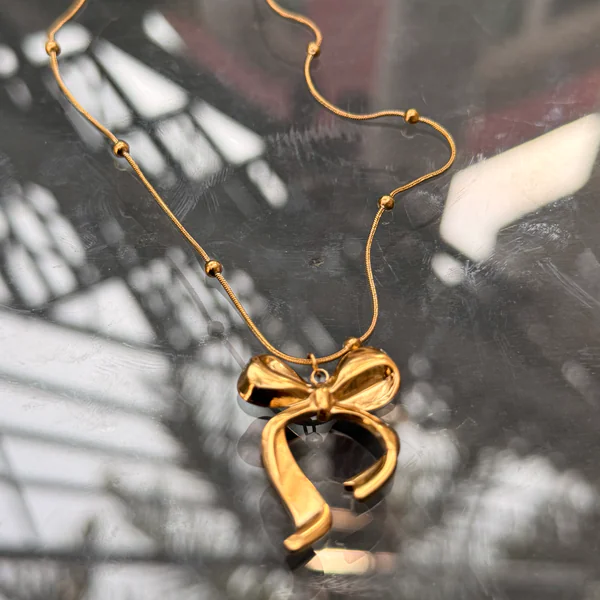 Golden Bow Chain - Necklaces from BLINGARI luxury Indian fashion collection